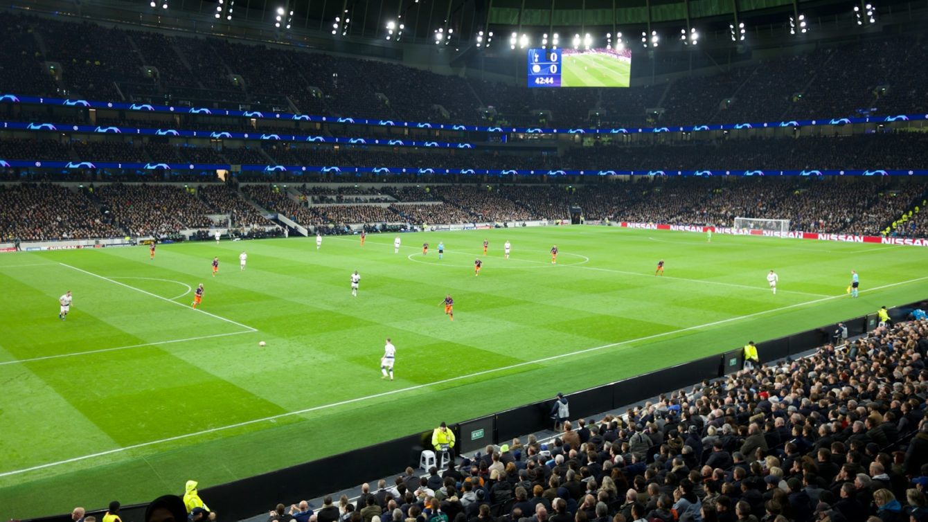 two teams playing soccer inside stadium