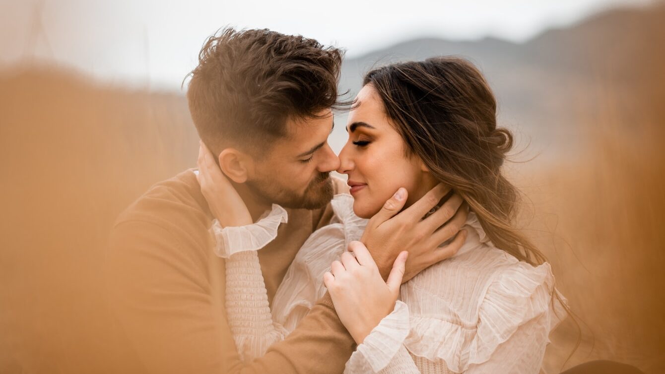 A man and a woman embracing in a field