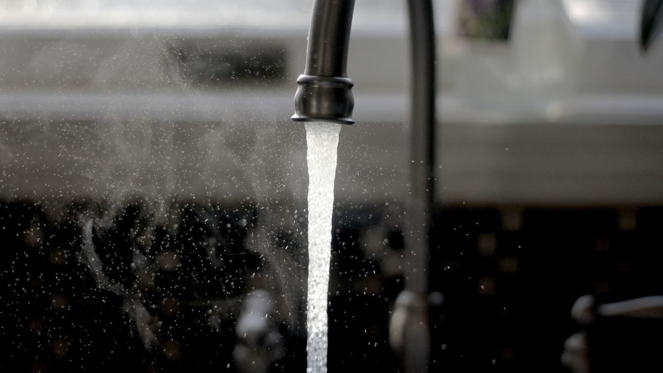 a faucet running water from a kitchen sink